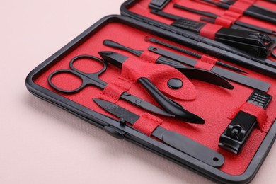 Kit of pedicure tools on beige background, closeup