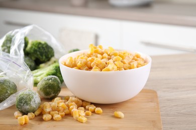 Frozen vegetables on wooden countertop in kitchen, closeup