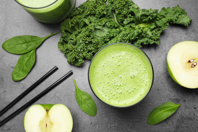 Photo of Flat lay composition with kale smoothie on grey table