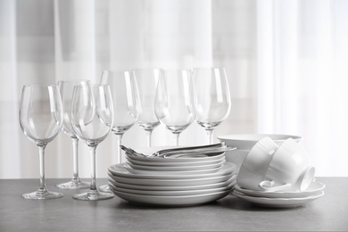 Set of clean dishes on the table against blurred background