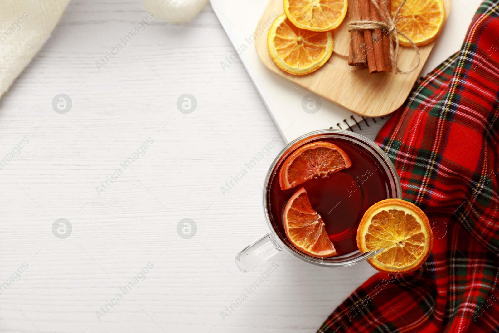 Photo of Flat lay composition with cup of tea on white wooden table, space for text. Cozy winter