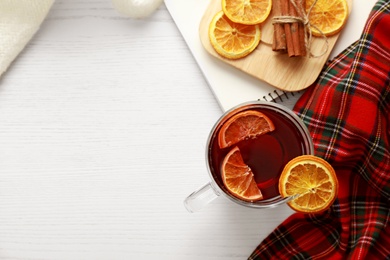 Photo of Flat lay composition with cup of tea on white wooden table, space for text. Cozy winter