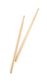 Photo of Two wooden drumsticks on white background, top view