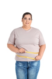 Overweight woman with measuring tape on white background