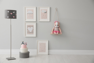Photo of Children's room interior with floor lamp and cute pictures on wall