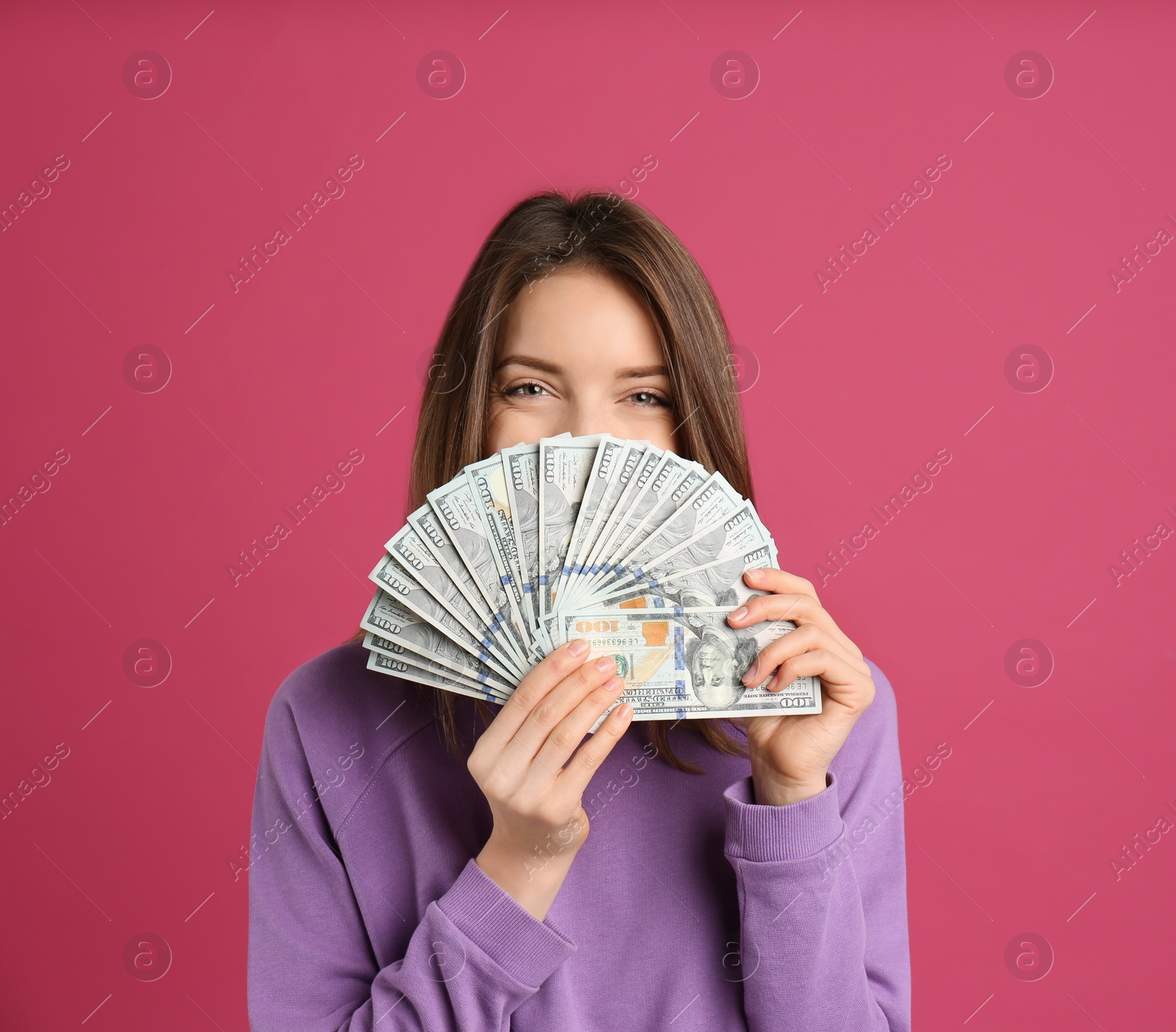Photo of Young woman with cash money on pink background. Space for text
