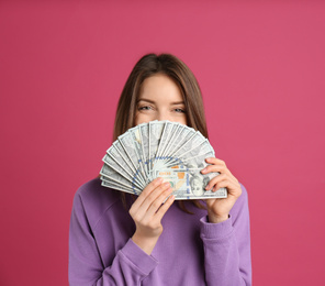 Photo of Young woman with cash money on pink background. Space for text