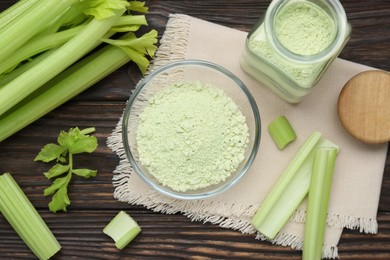 Photo of Natural celery powder and fresh stalks on wooden table, flat lay