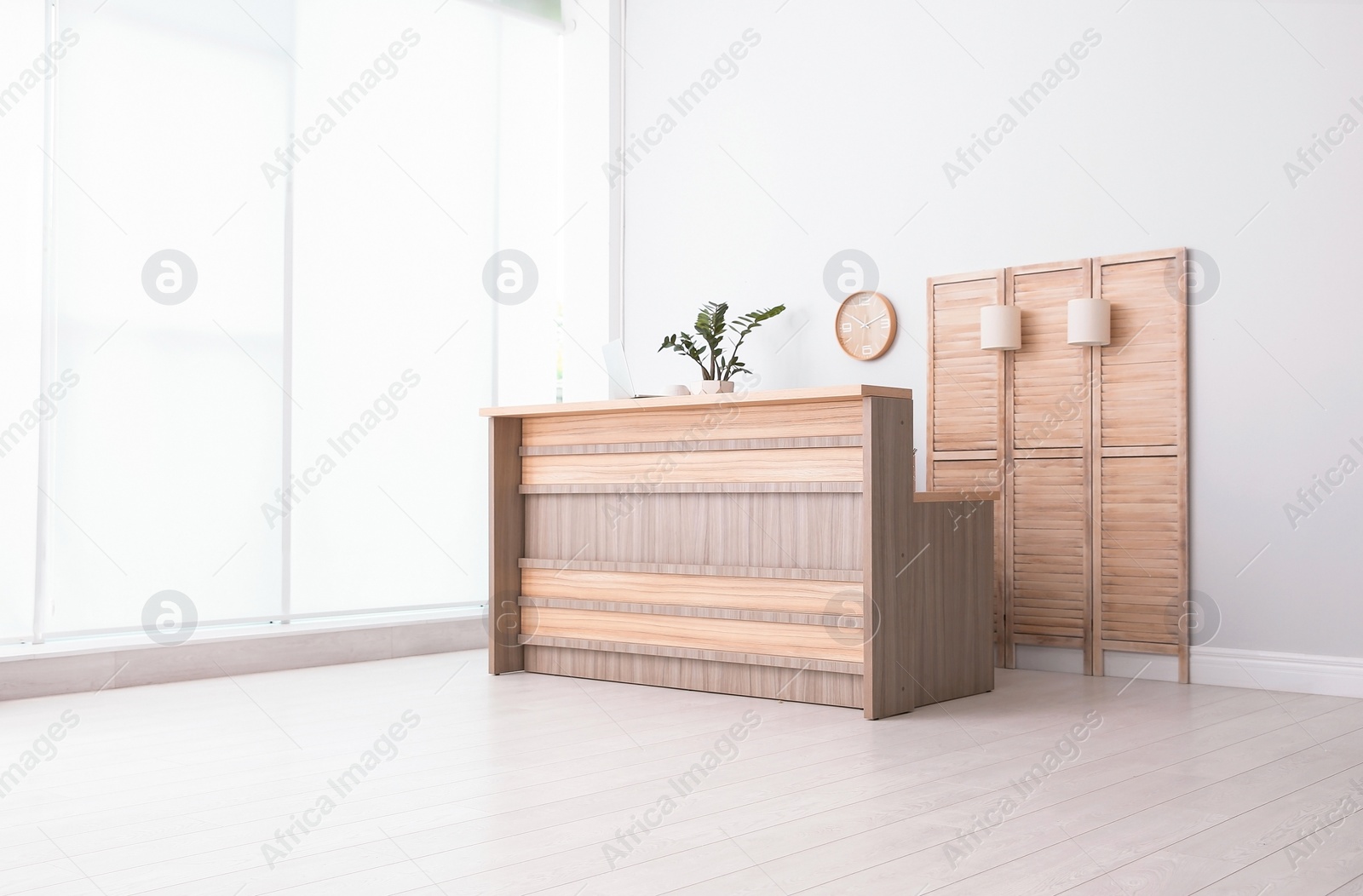 Photo of Hotel lobby interior with wooden reception desk