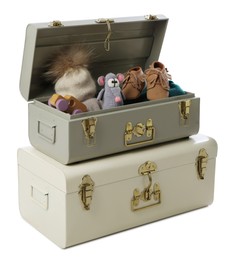 Photo of Stylish storage trunks with child's shoes and toys on white background. Interior elements