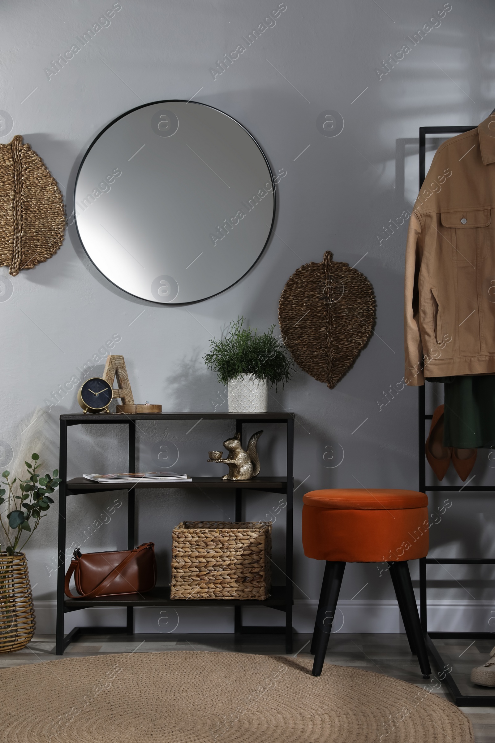 Photo of Stylish room interior with console table and beautiful decor elements