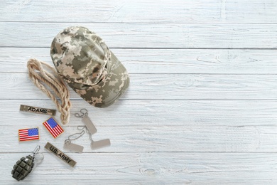 Set of military outfit on wooden background, flat lay