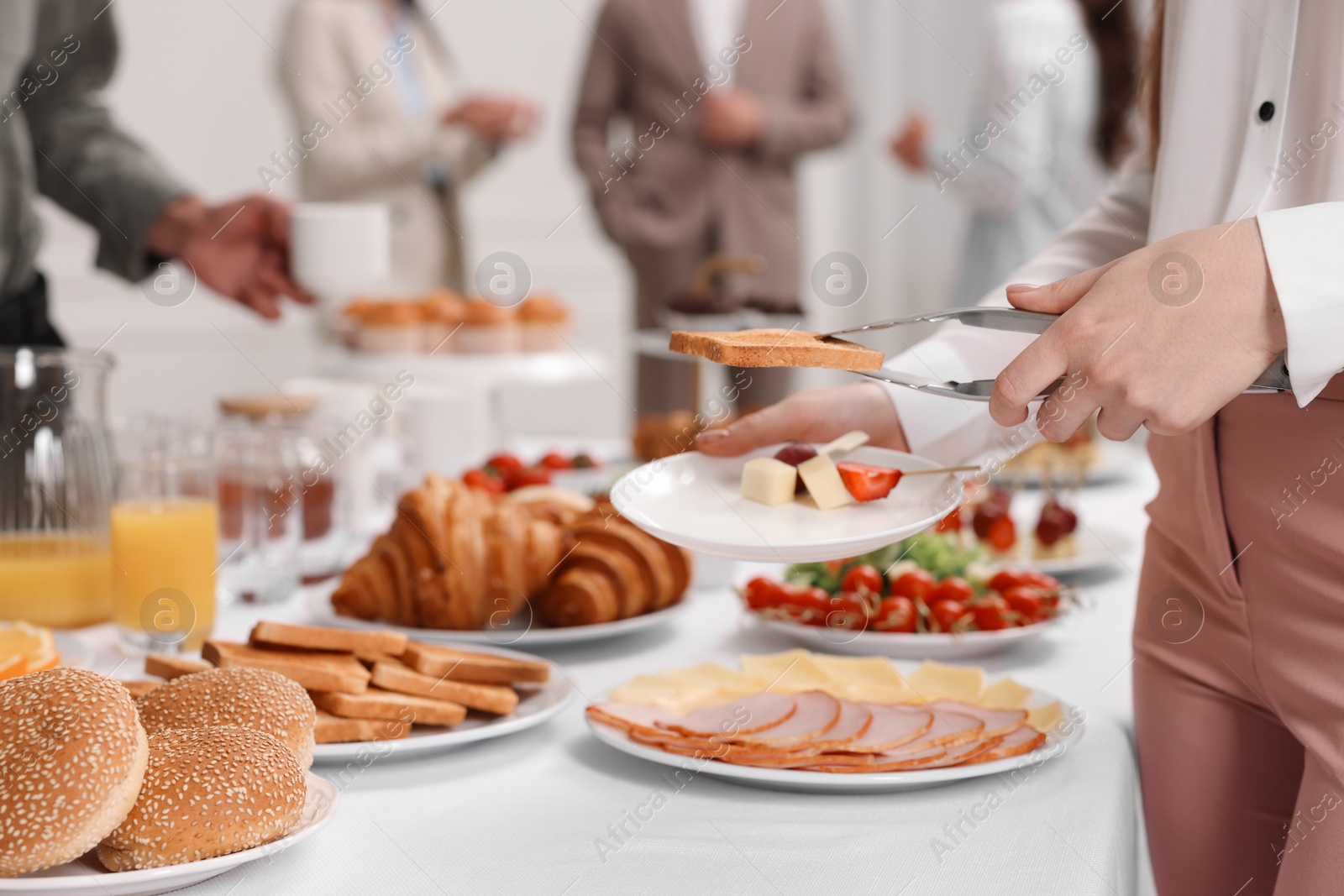 Photo of Coworkers having business lunch in restaurant, closeup