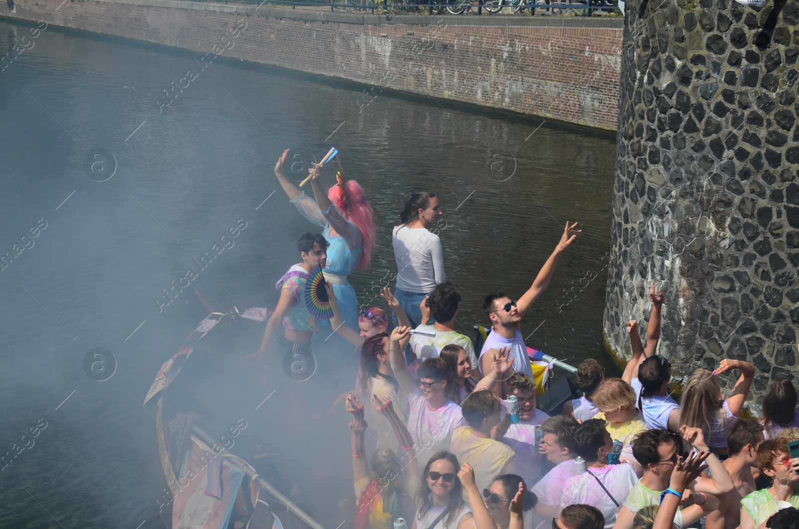 Photo of AMSTERDAM, NETHERLANDS - AUGUST 06, 2022: Many people in boat at LGBT pride parade on river