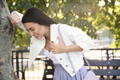 Photo of Young woman having heart attack in park