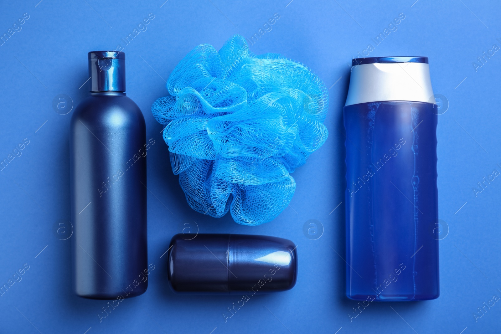 Photo of Flat lay composition with men's cosmetic products on blue background