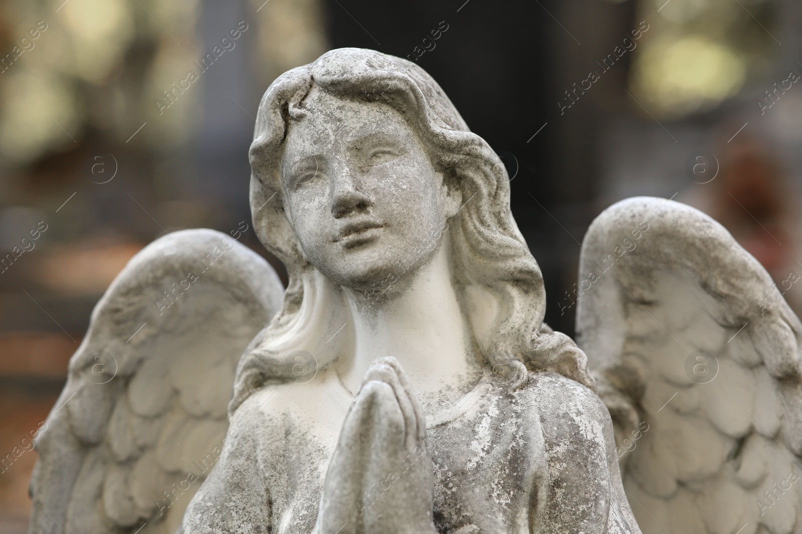 Photo of Beautiful statue of angel at cemetery, closeup. Religious symbol