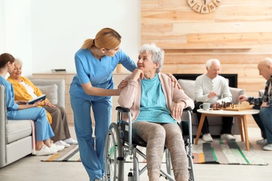 Nurses assisting elderly people at retirement home