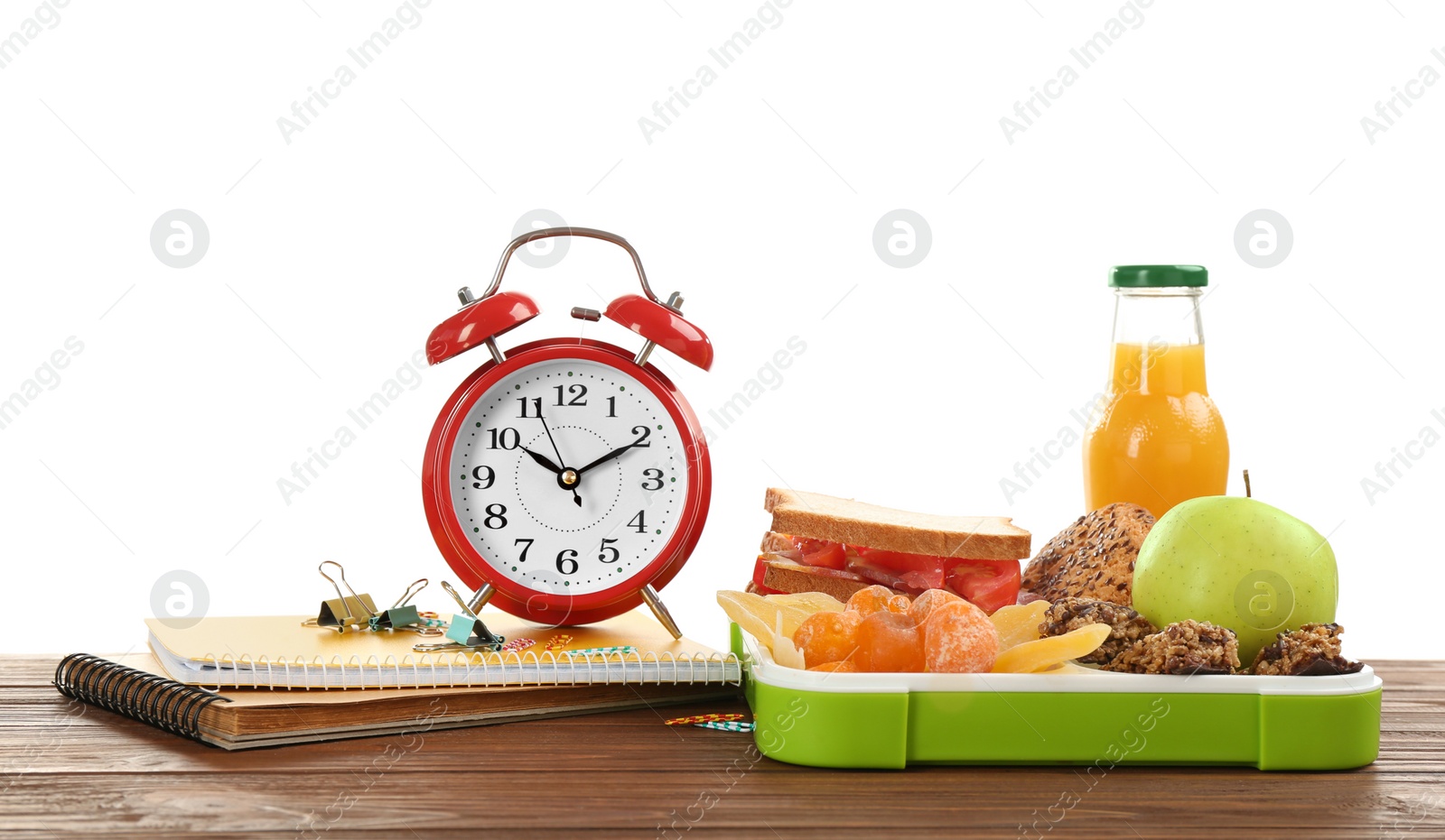 Photo of Lunch box with appetizing food and alarm clock on table against white background