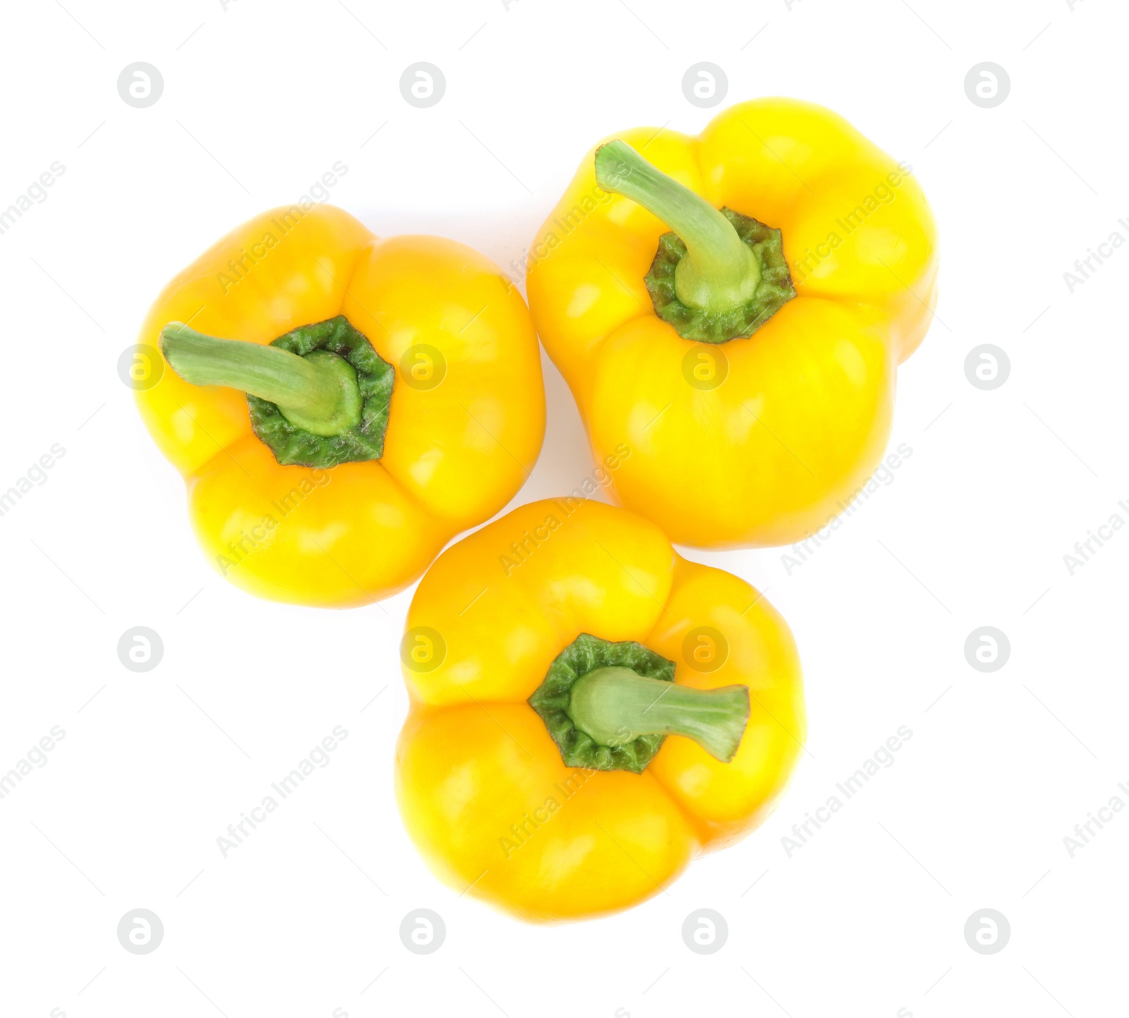 Photo of Ripe yellow bell peppers isolated on white, top view