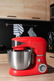 Photo of Modern stand mixer on wooden table in kitchen