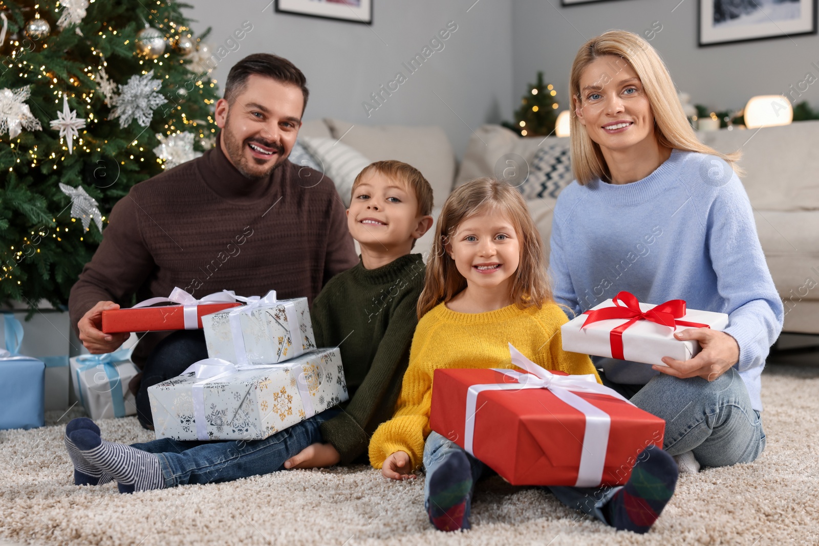 Photo of Happy family with Christmas gifts at home