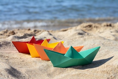 Many paper boats near sea on sunny day