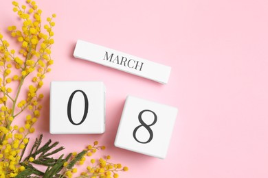 Photo of International Women's day - 8th of March. Wooden block calendar, beautiful flowers and space for text on pink background, flat lay