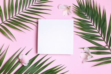 Photo of Flat lay composition with tropical leaves and Hibiscus flowers on pink background. Space for text