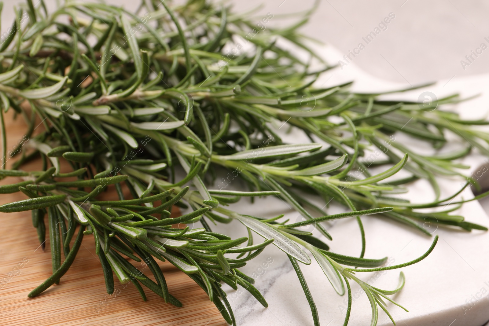 Photo of Sprigs of fresh rosemary on board, closeup