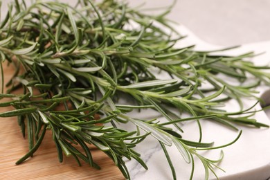 Photo of Sprigs of fresh rosemary on board, closeup