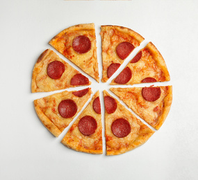 Photo of Tasty pepperoni pizza on white table, flat lay