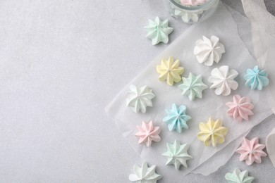 Tasty meringue cookies on light grey table, flat lay. Space for text