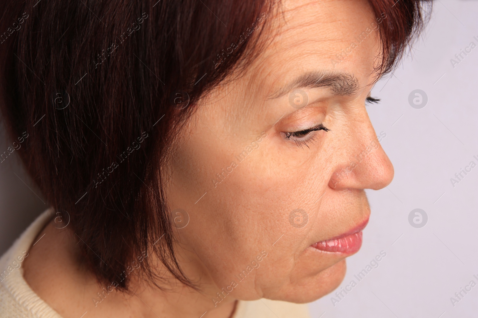 Photo of Skin care. Senior woman on white background, closeup