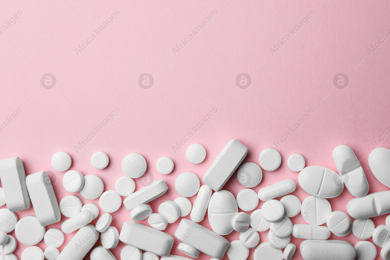 Photo of Different pills on color background, top view. Space for text