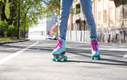 Woman roller skating outdoors on sunny day, closeup