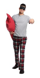 Photo of Somnambulist with blindfold and red pillow on white background. Sleepwalking