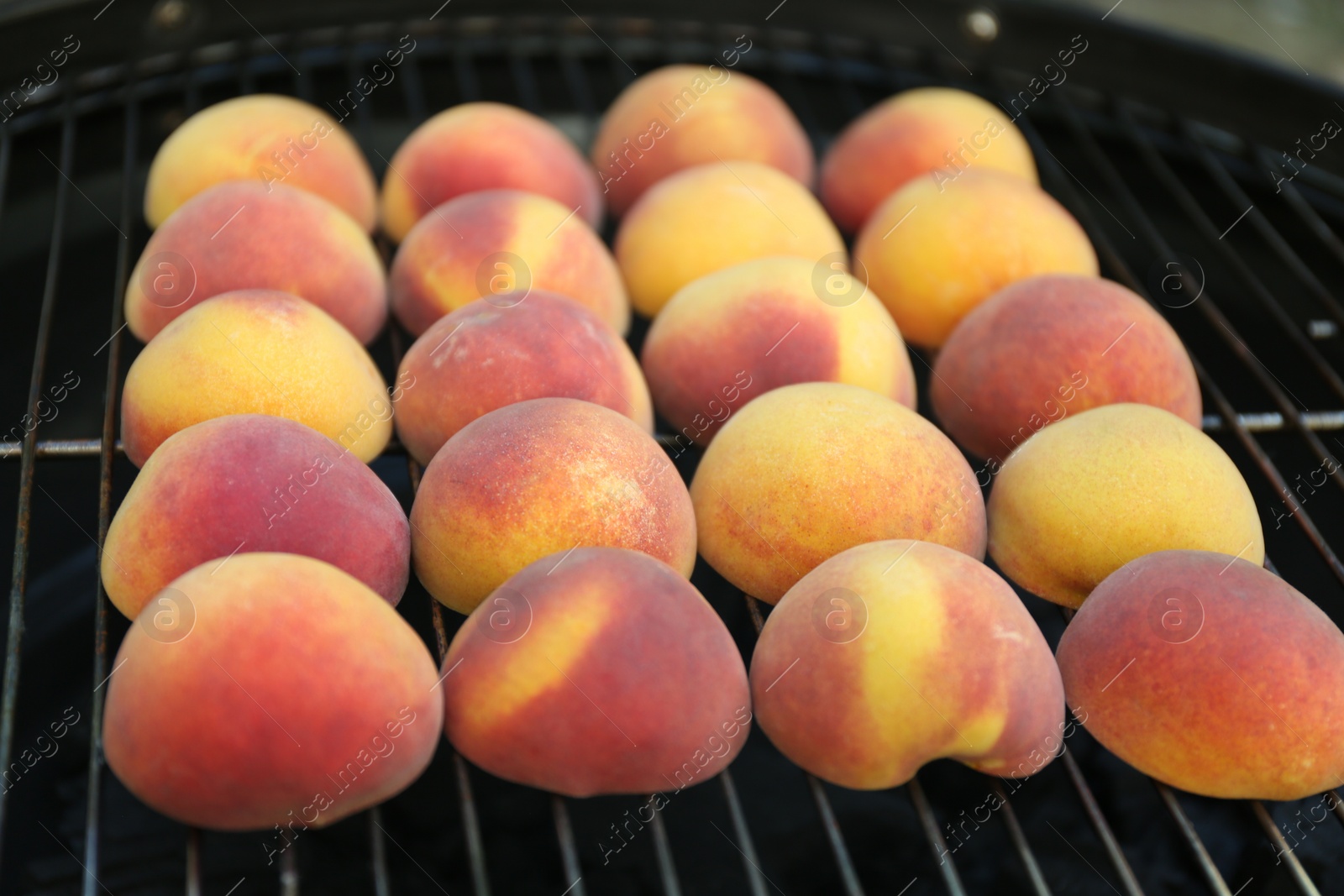 Photo of Modern grill with tasty juicy peaches, closeup