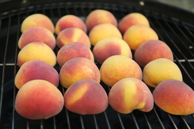 Photo of Modern grill with tasty juicy peaches, closeup