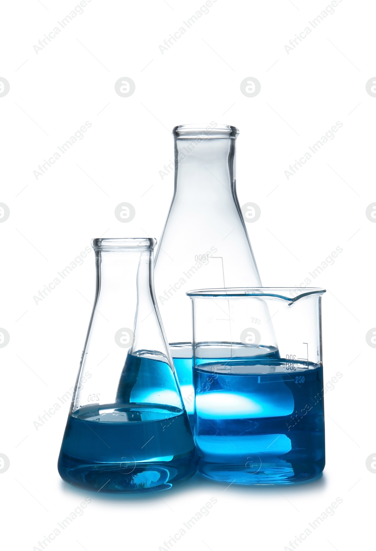 Photo of Laboratory glassware with liquid on table against white background. Chemical analysis