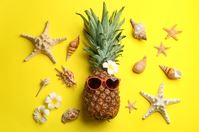 Photo of Flat lay composition with pineapple on yellow background. Creative concept