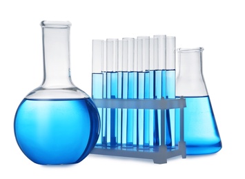 Set of laboratory glassware with blue liquid on white background