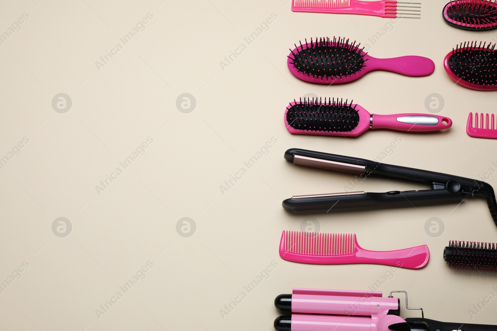 Photo of Flat lay composition of professional hairdresser tools on beige table, space for text