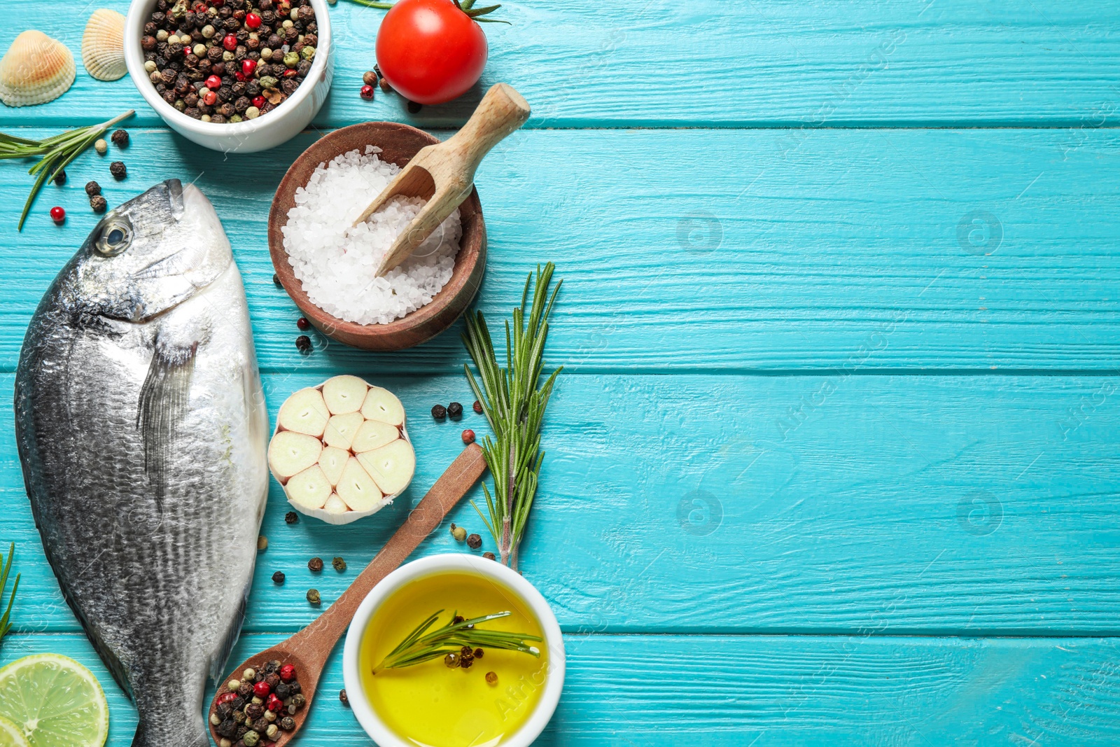 Photo of Flat lay composition with raw dorada fish on light blue wooden table, space for text