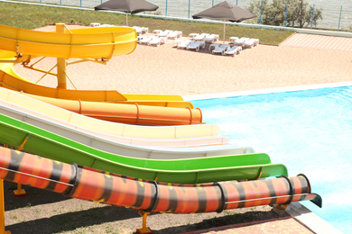 Different colorful slides in water park on sunny day