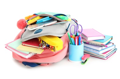 Backpack and school stationery on white background