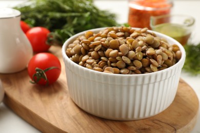 Delicious lentils in bowl served on table, closeup