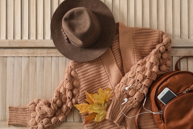 Photo of Flat lay composition with cozy knitted sweater on wooden background