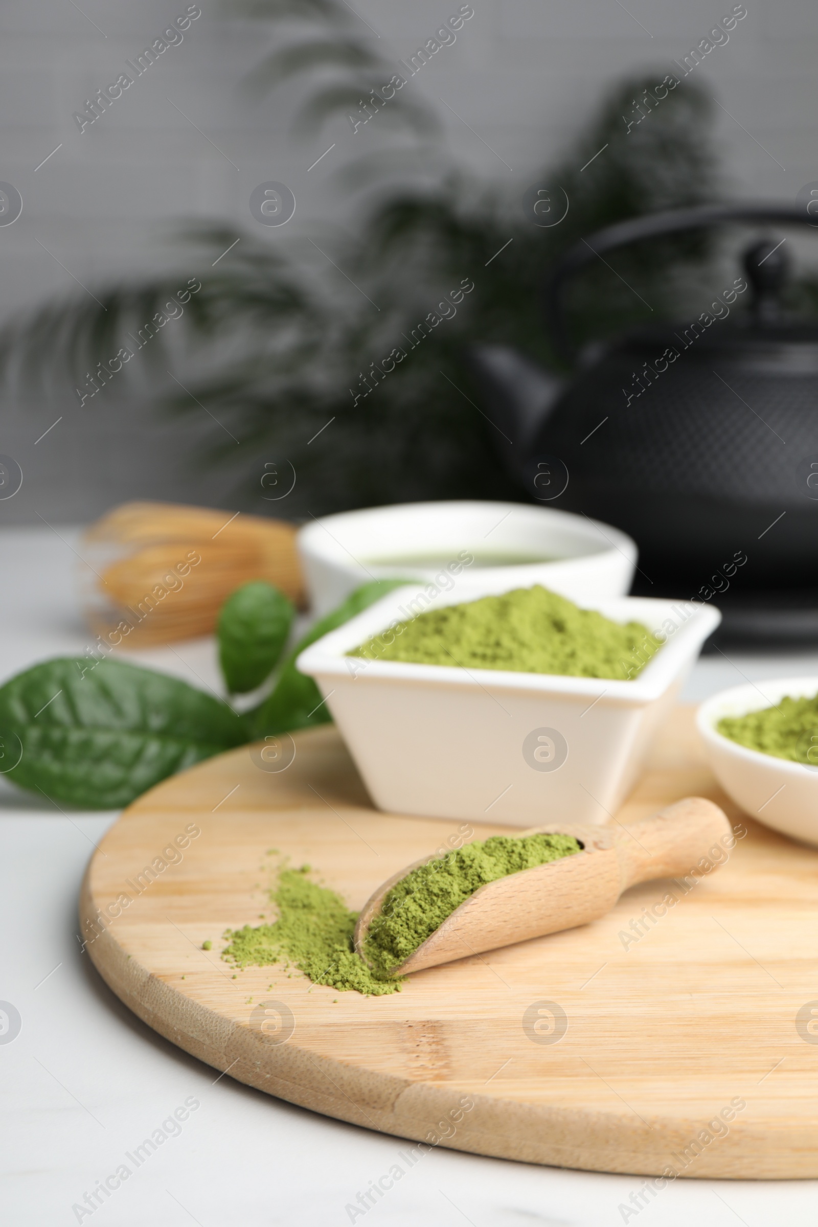 Photo of Green matcha powder on white table indoors, space for text