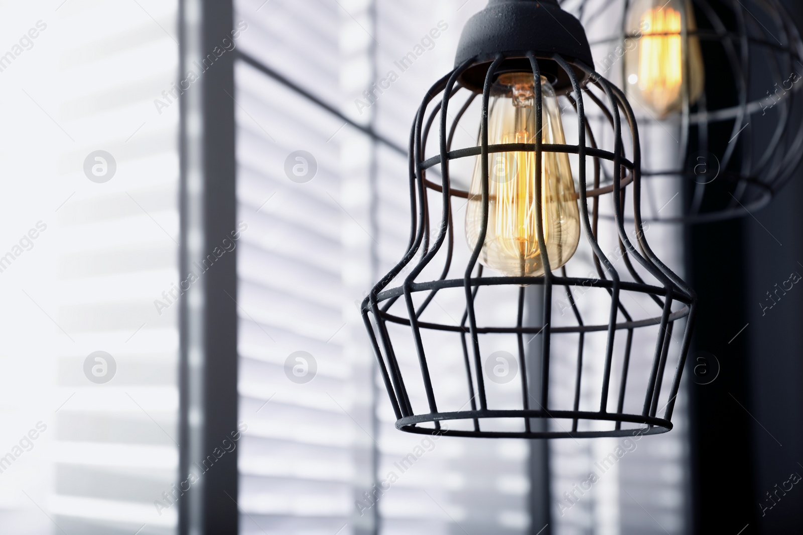 Image of Stylish metallic pendant lamp with Edison light bulb indoors